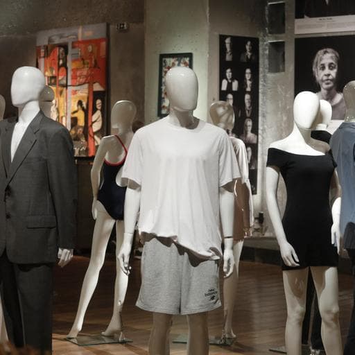 Mannequins wearing casual clothes and suits before portrait photos in gallery.